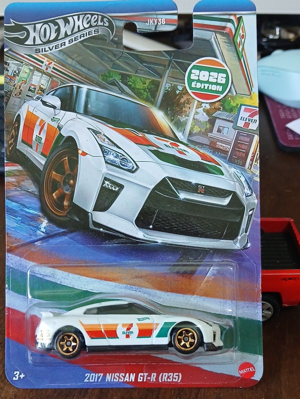 2017 Nissan GT-R (R35) Toy Car — White with Orange & Green 7-Eleven Livery